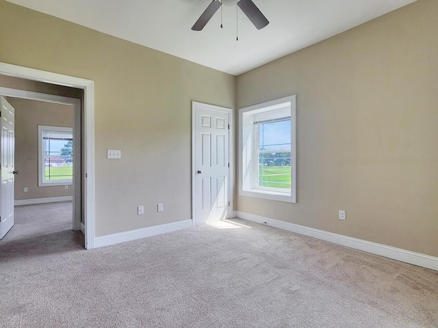 unfurnished bedroom with ceiling fan and light carpet