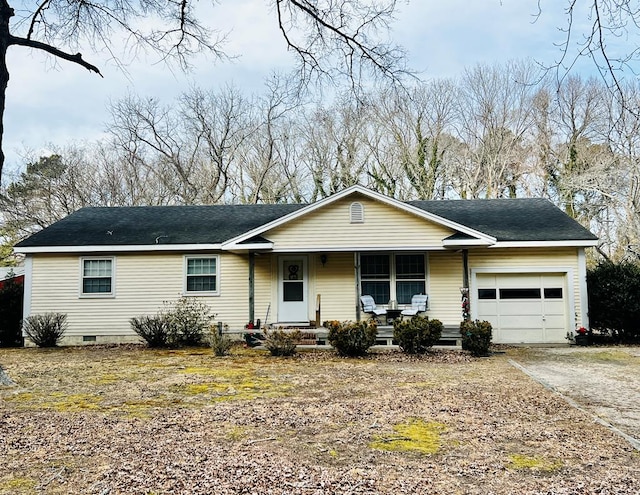 ranch-style home featuring a garage and covered porch