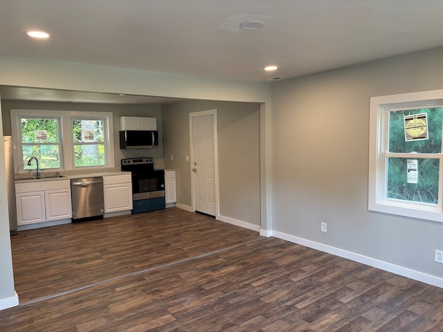 kitchen featuring dark hardwood / wood-style flooring, white cabinetry, sink, and appliances with stainless steel finishes