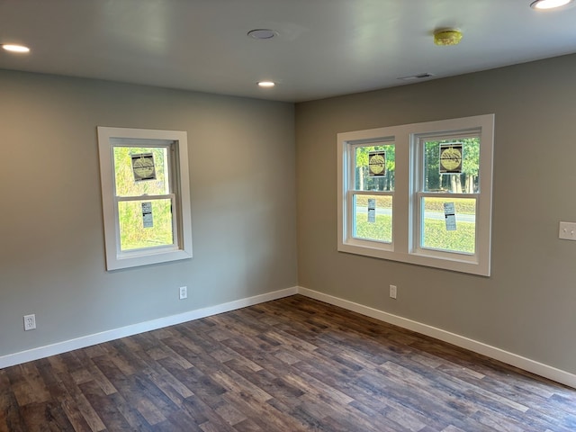 empty room with dark hardwood / wood-style flooring