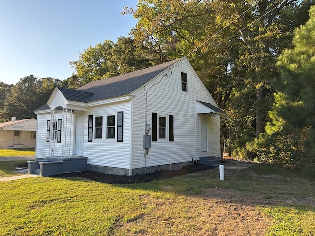 view of side of home featuring a yard