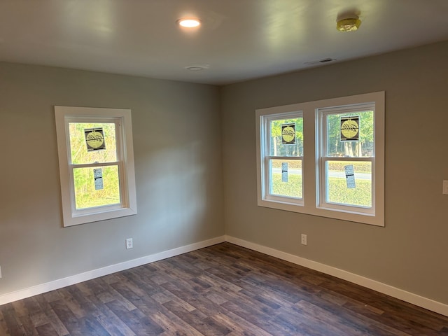 unfurnished room with dark wood-type flooring