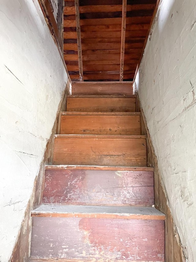 stairway with wooden ceiling