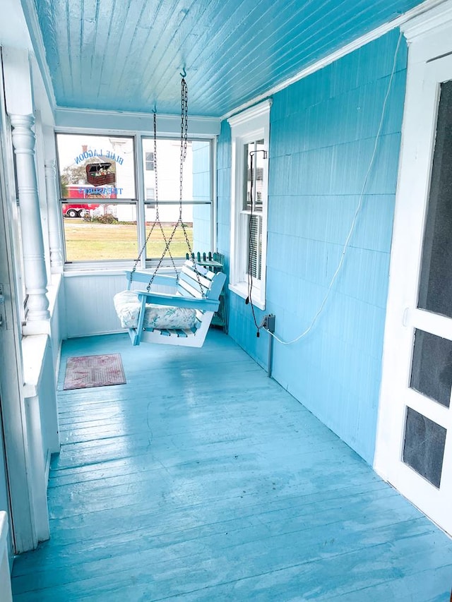 unfurnished sunroom with wooden ceiling