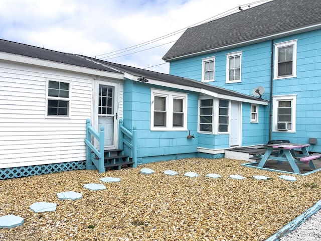 rear view of property with cooling unit