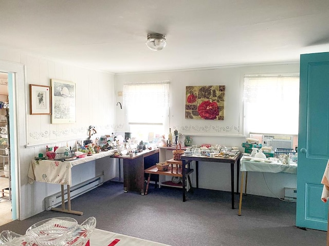 miscellaneous room with carpet floors, a baseboard heating unit, and cooling unit