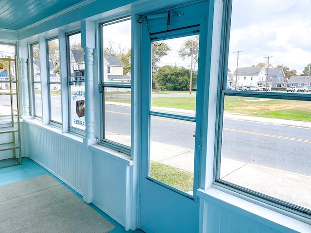 doorway to outside with ornamental molding