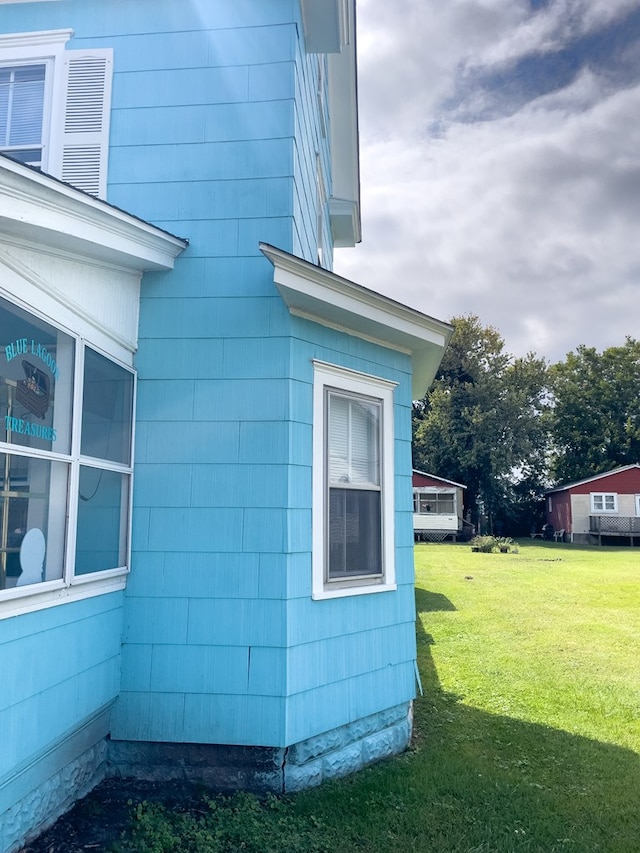 view of home's exterior with a lawn