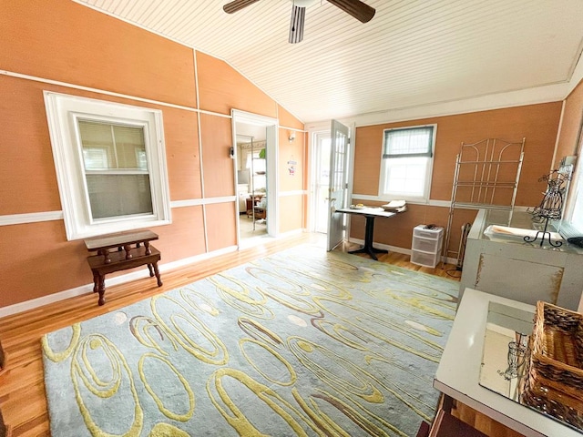 interior space with hardwood / wood-style flooring, ceiling fan, and lofted ceiling