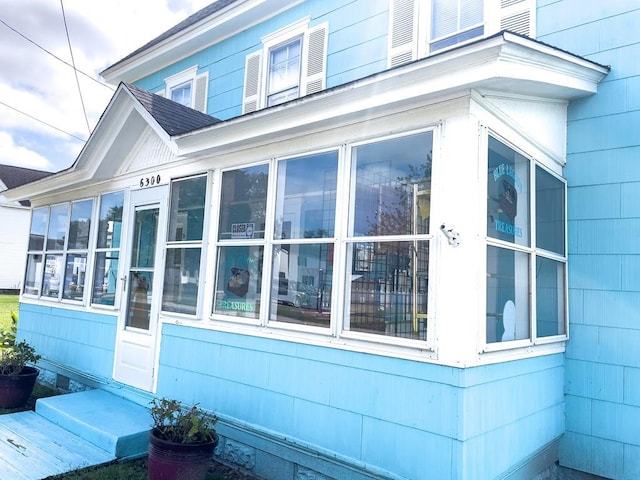 view of property exterior featuring a sunroom