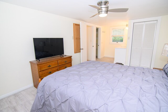 bedroom with ceiling fan, a closet, and light wood-type flooring