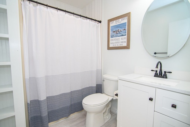 bathroom featuring vanity, hardwood / wood-style flooring, and toilet