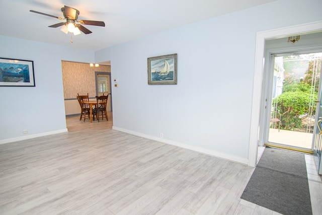 empty room with light wood-type flooring and ceiling fan