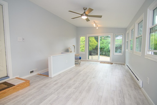 unfurnished room featuring ceiling fan, lofted ceiling, baseboard heating, and light hardwood / wood-style flooring