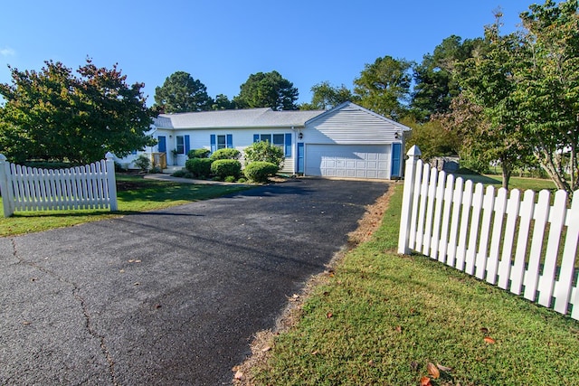 single story home with a garage and a front lawn