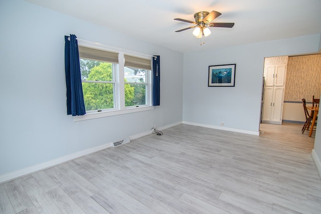 unfurnished room with ceiling fan and light wood-type flooring