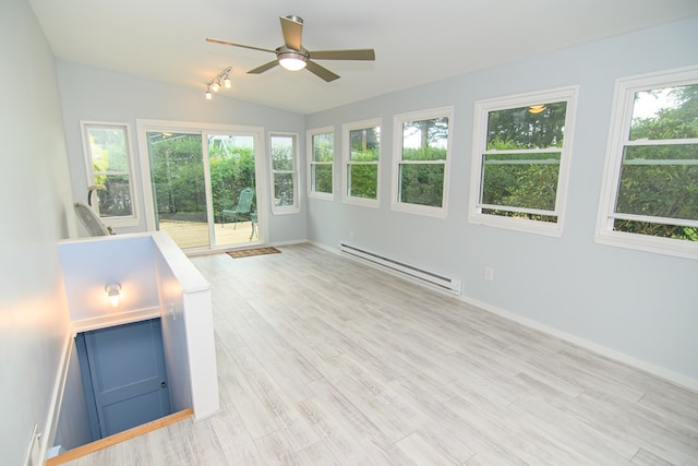 unfurnished sunroom featuring vaulted ceiling, ceiling fan, and a baseboard heating unit