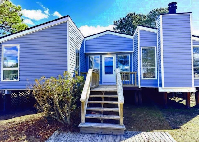 exterior space with a wooden deck and stairs