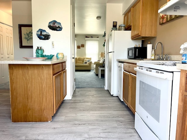 kitchen featuring white appliances, exhaust hood, and light hardwood / wood-style flooring