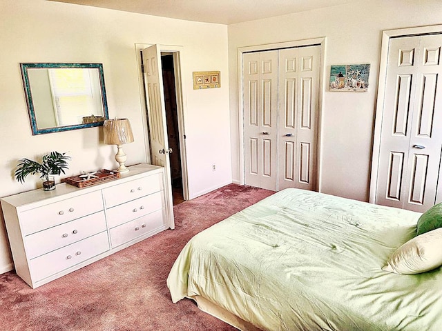 carpeted bedroom featuring multiple closets