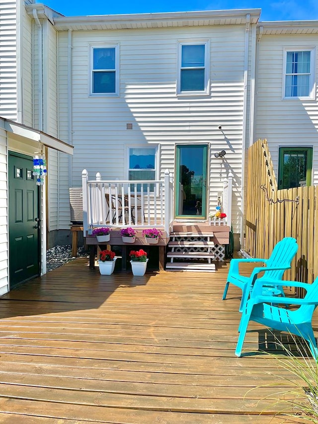 rear view of house featuring a deck