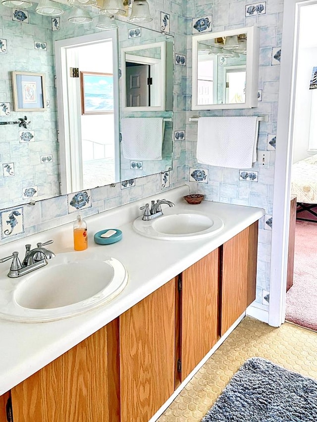 bathroom featuring tile patterned floors, vanity, and backsplash