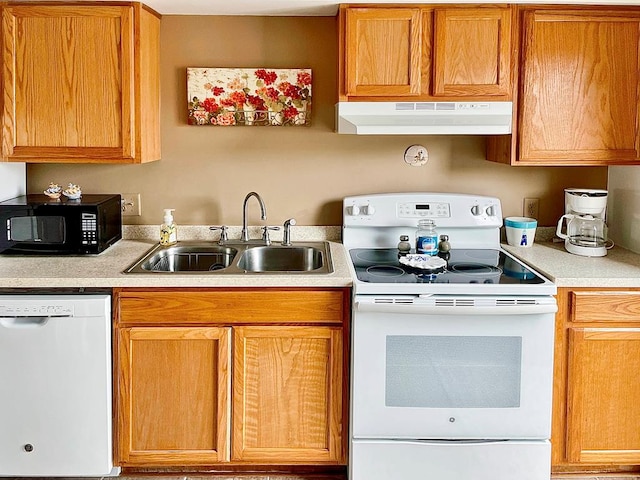 kitchen featuring white appliances and sink