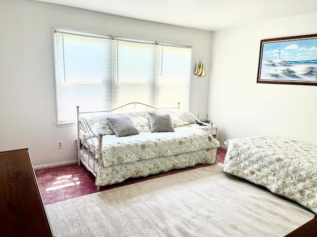 carpeted bedroom featuring multiple windows