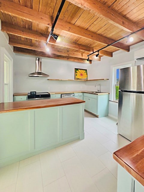 4169 Main St, Chincoteague, VA 23336 - kitchen with freestanding refrigerator, wall chimney range hood, open shelves, wooden ceiling with exposed beams, and track lighting