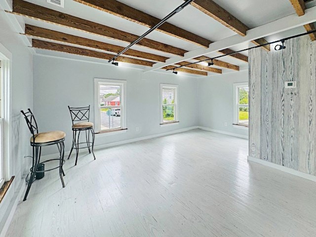 4169 Main St, Chincoteague, VA 23336 - unfurnished room with beamed ceiling, wood finished floors, and baseboards