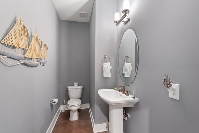 199 Old Course Loop, Cape Charles, VA 23310 - half bathroom with a sink, toilet, baseboards, visible vents, and wood finished floors