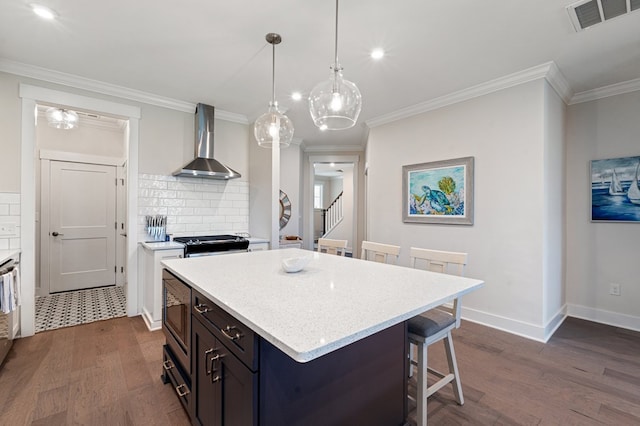 199 Old Course Loop, Cape Charles, VA 23310 - kitchen featuring a kitchen bar, stainless steel microwave, wall chimney exhaust hood, dark wood-type flooring, and visible vents