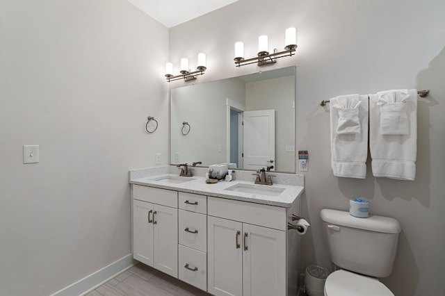 199 Old Course Loop, Cape Charles, VA 23310 - bathroom with baseboards, a sink, double vanity, and toilet