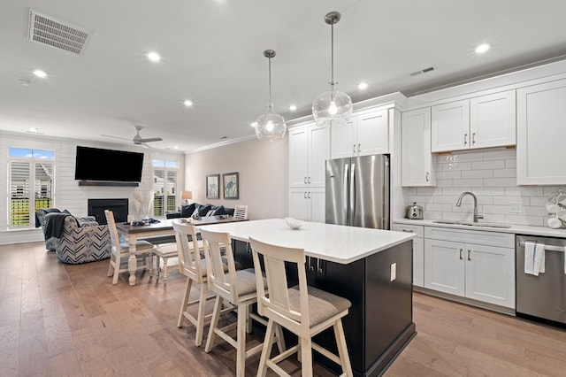 199 Old Course Loop, Cape Charles, VA 23310 - kitchen featuring visible vents, a sink, a fireplace, appliances with stainless steel finishes, and ceiling fan