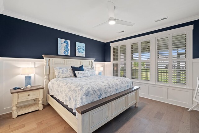 199 Old Course Loop, Cape Charles, VA 23310 - bedroom featuring crown molding, wood finished floors, visible vents, and a decorative wall