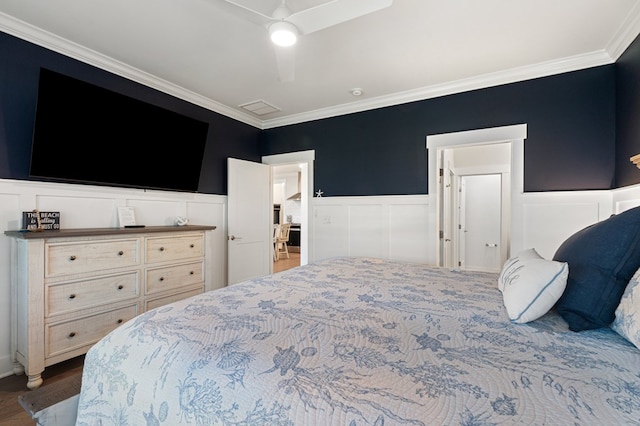 199 Old Course Loop, Cape Charles, VA 23310 - bedroom featuring a wainscoted wall, wood finished floors, ornamental molding, and a decorative wall