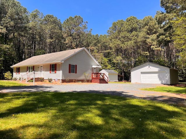 12255 Indian Trail Rd, Belle Haven, VA 23306 - view of front of house featuring covered porch, a wooded view, an outbuilding, a detached garage, and a front yard