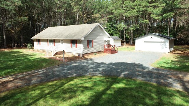 12255 Indian Trail Rd, Belle Haven, VA 23306 - view of front of property featuring a front lawn, crawl space, a garage, an outbuilding, and a forest view