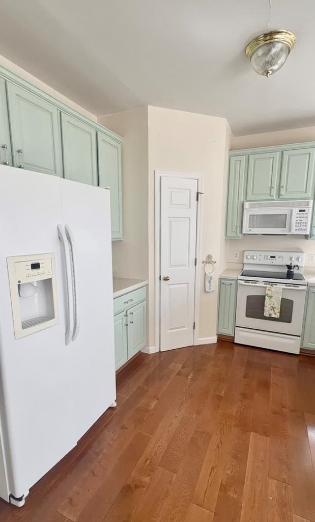 15259 Russell Dr, Onancock, VA 23417 - kitchen with white appliances, light countertops, and dark wood-style floors