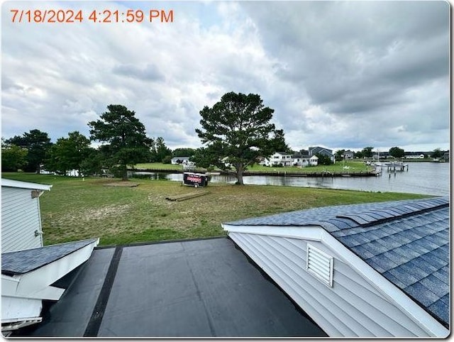 exterior space with a yard, a water view, and a patio area