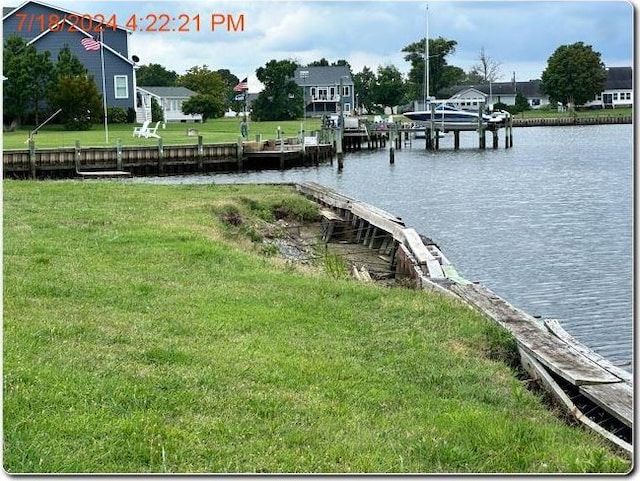 dock area featuring a water view and a yard