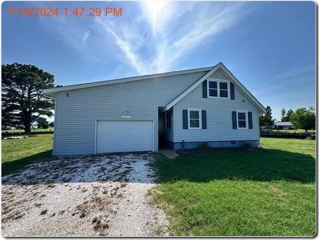 view of front of property with a front yard and a garage