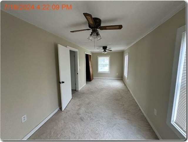 spare room featuring light carpet and ceiling fan