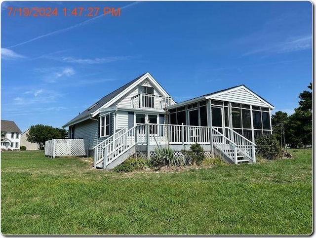 view of front of home with a sunroom and a front yard