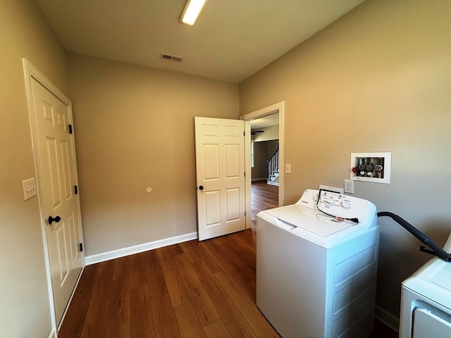 laundry room with dark wood finished floors, visible vents, washer / dryer, and laundry area