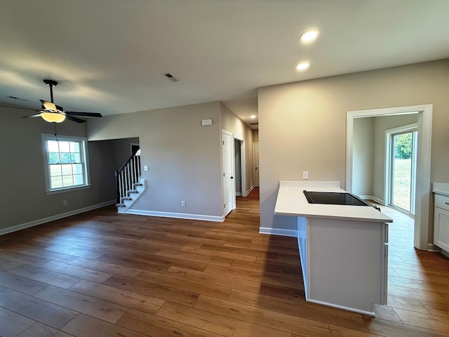 interior space with visible vents, wood finished floors, recessed lighting, stairway, and baseboards