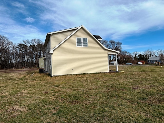 view of home's exterior featuring central AC unit and a lawn