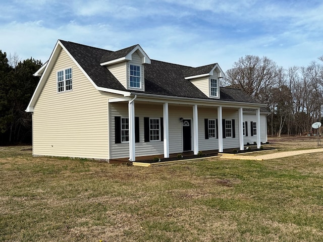 cape cod-style house with a front lawn and a shingled roof