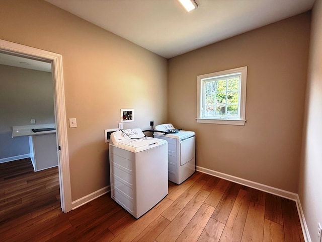 laundry room featuring hardwood / wood-style floors, laundry area, baseboards, and washing machine and clothes dryer