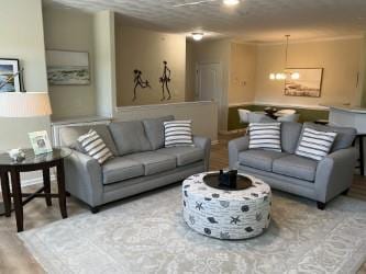 living room featuring a notable chandelier